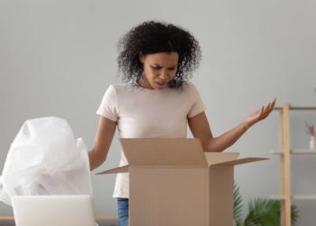 Disappointed shocked frustrated african woman customer open cardboard box receive damaged wrong parcel, annoyed black girl consumer having problem with bad shopping order displeased by post shipping